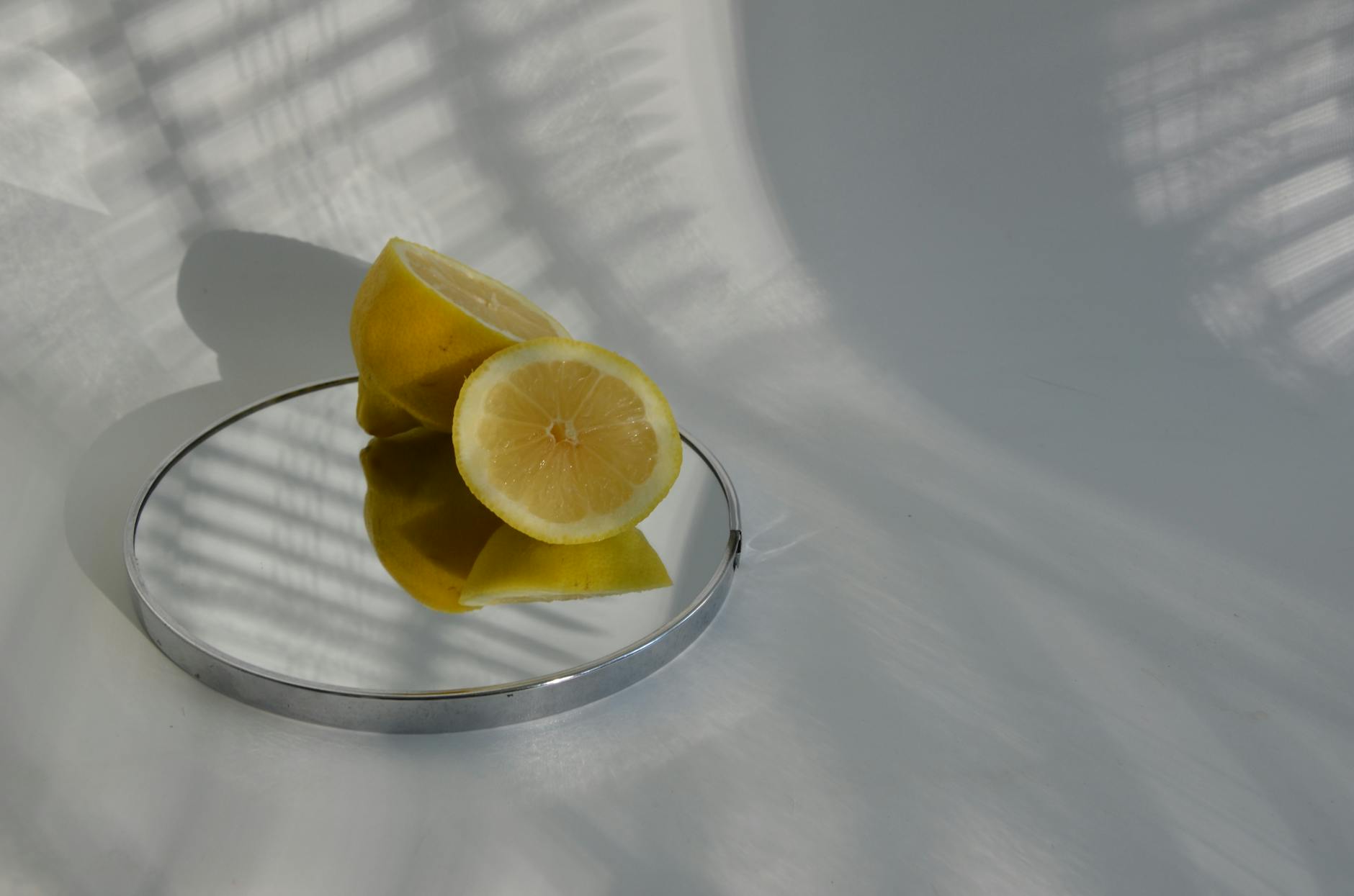 Limoni freschi disposti su uno sfondo verde pastello, simbolo di rinascita e ritorno della sensibilità naturale.